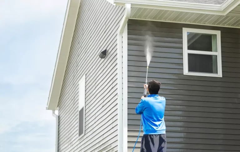 a man doing house washing west lake hills tx